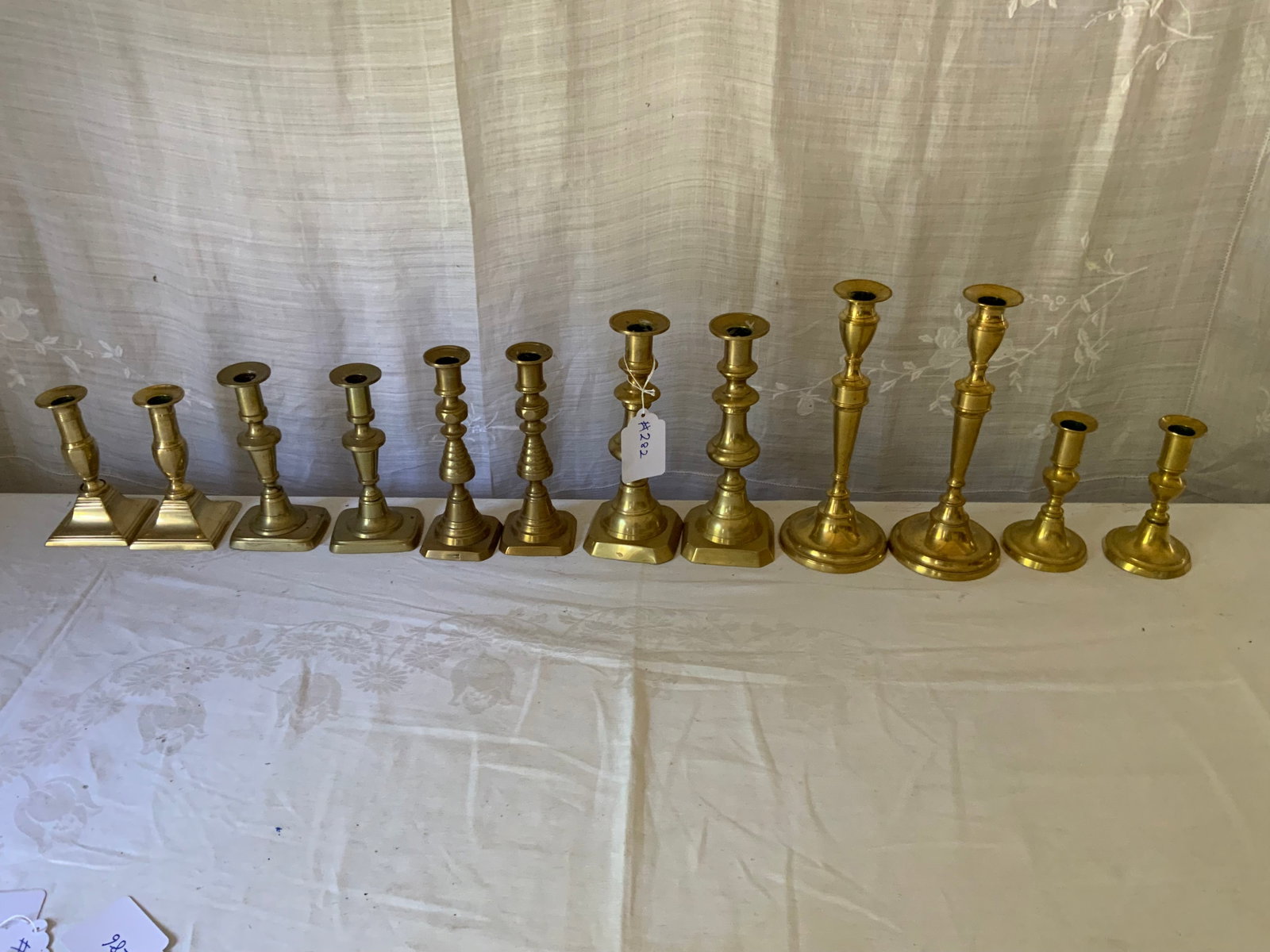 Push-Up Brass Candlesticks: Push-up brass candlesticks, 6 pairs, various sizes from 5 1/2" to 10 1/2" tall (one attributed to JD Price), beehive and Chippendale patterns, one marked England. Good condition.