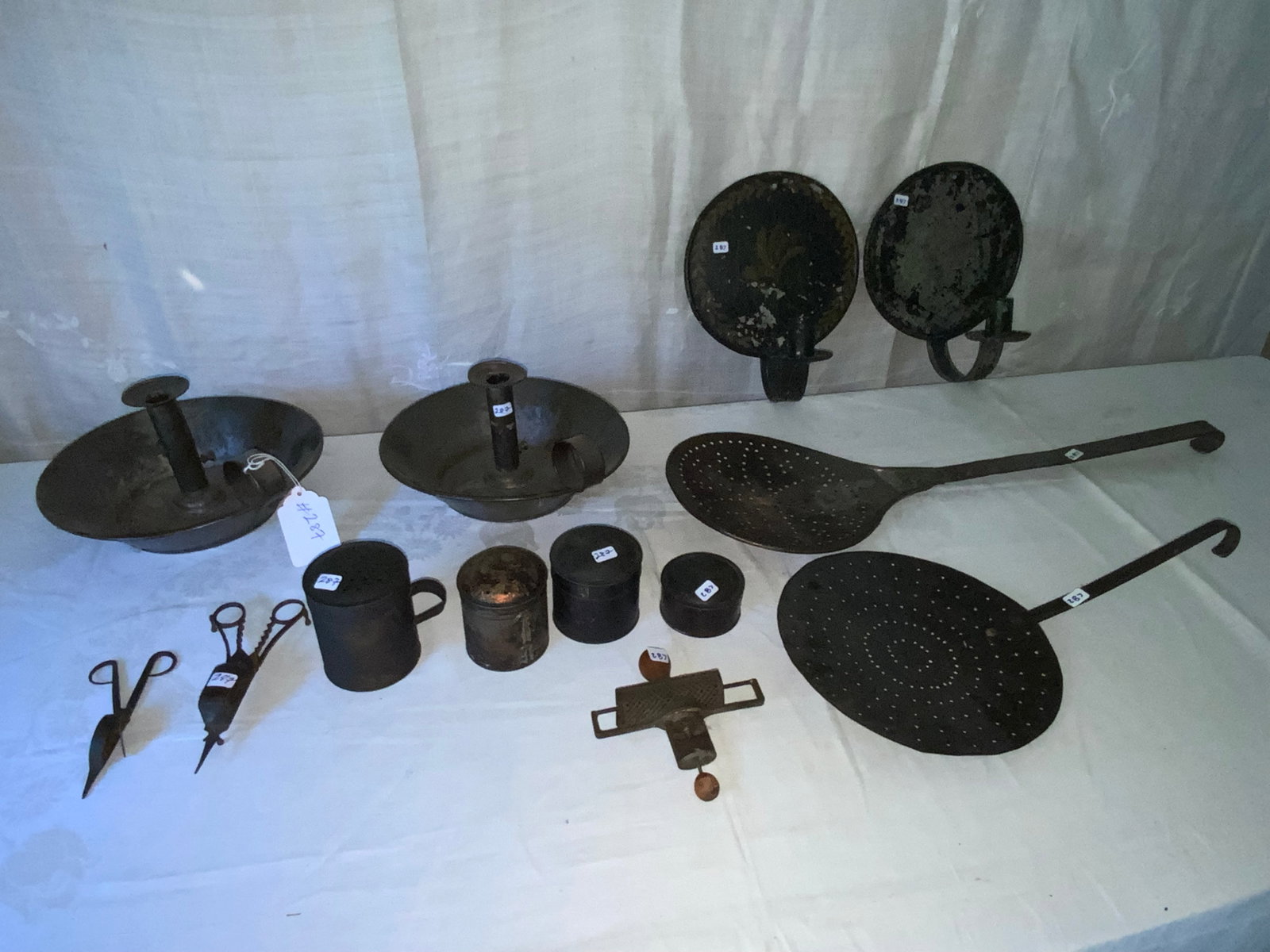 Tin Ware Lot: Tin ware lot: 2 sconces, 2 candle snuffers, 2 ladles, 1 nutmeg grinder, 2 shakers, 2 covered tins. Good condition.
