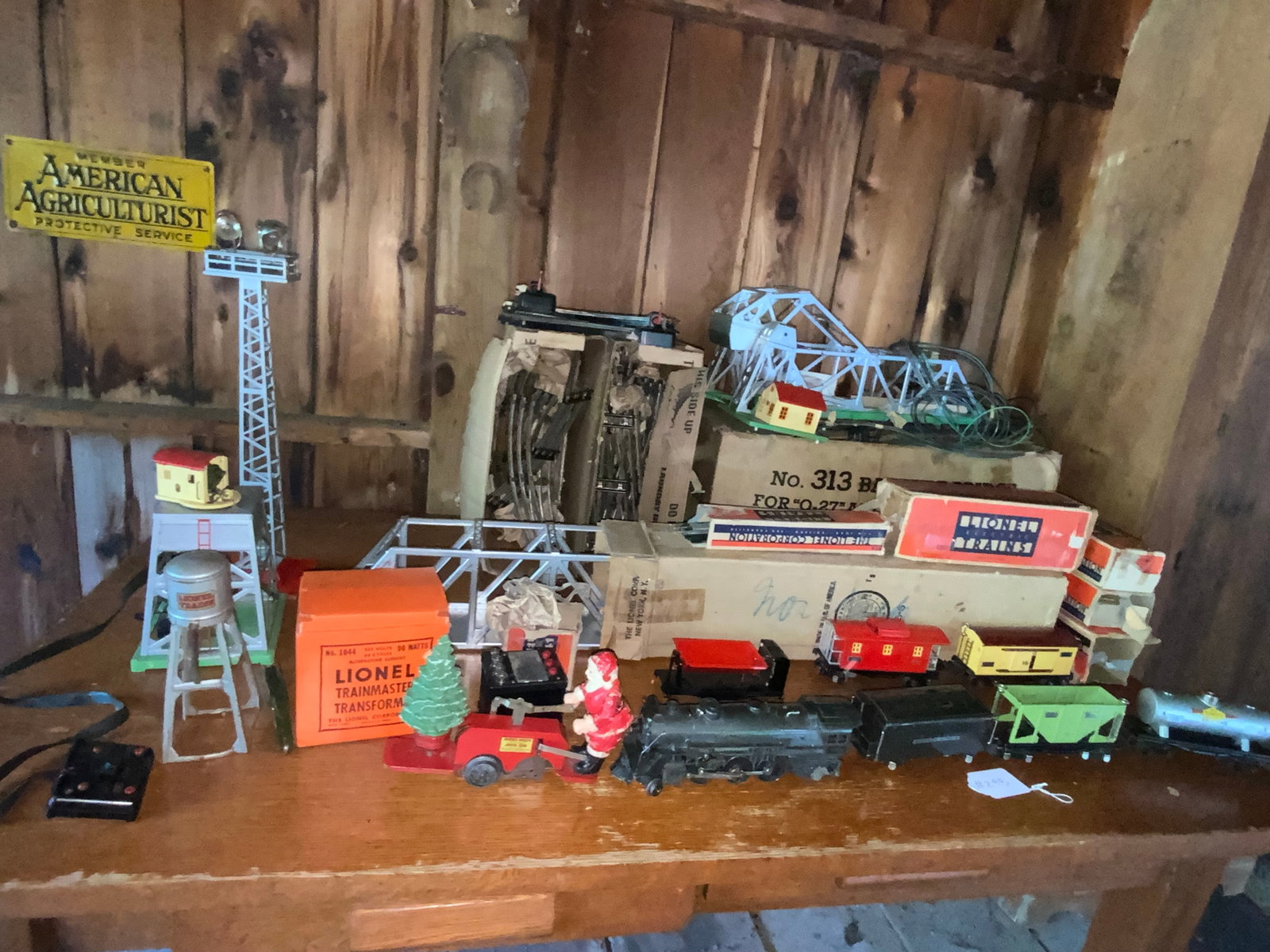 Lionel Train Set: Lionel train set, O gauge, 225E engine, coal car, Mickey Mouse Santa car #1105, Sunoco gas car #2654, 4 more cars, transformer w/ whistle control, box of track, #313 bridge and more. Good condition, s