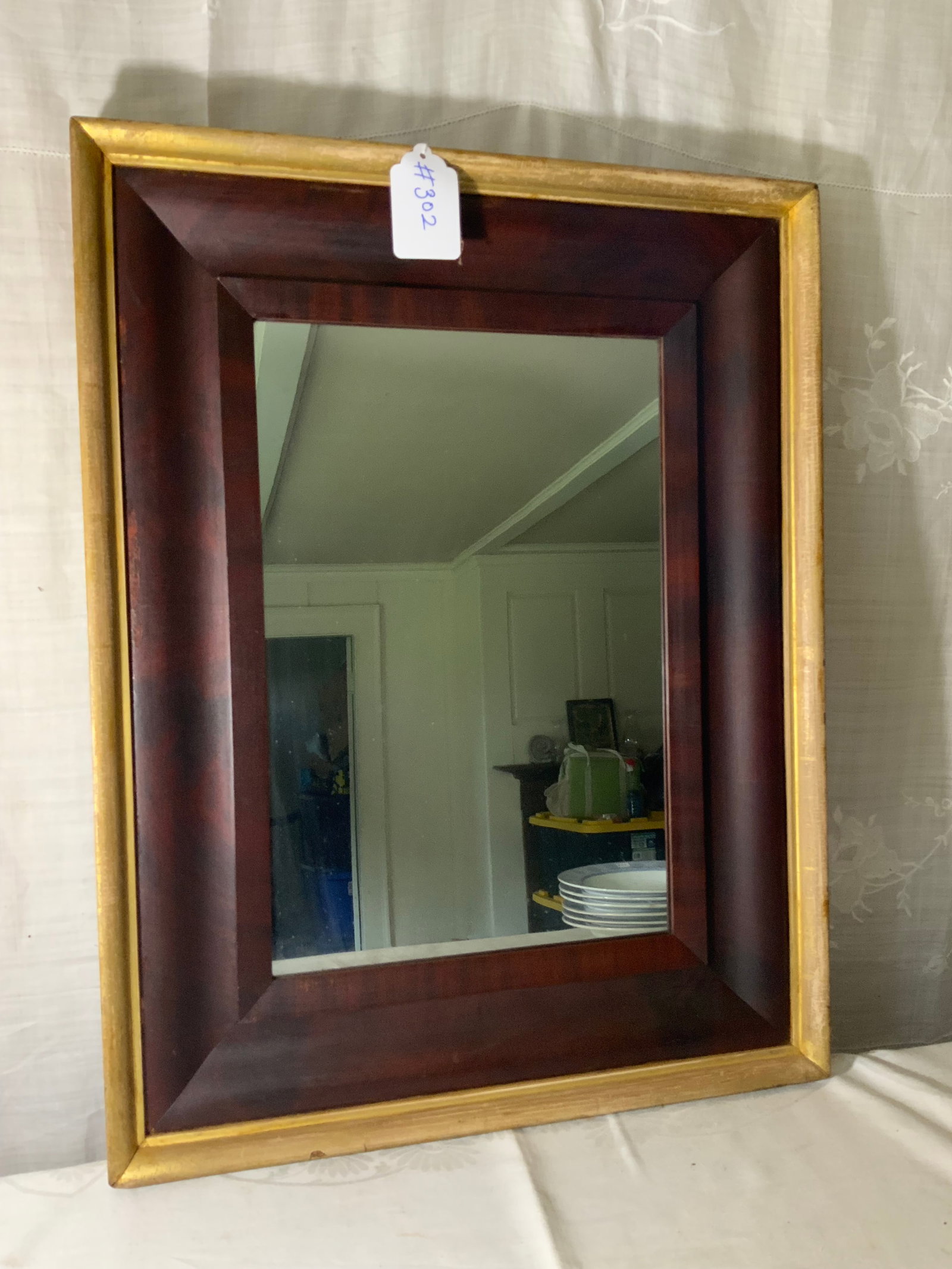 Ogee Mirror: Ogee mirror, 26" tall x 20" wide, w/ gold bordered frame. Good condition. Back notes it was purchased in 1857.