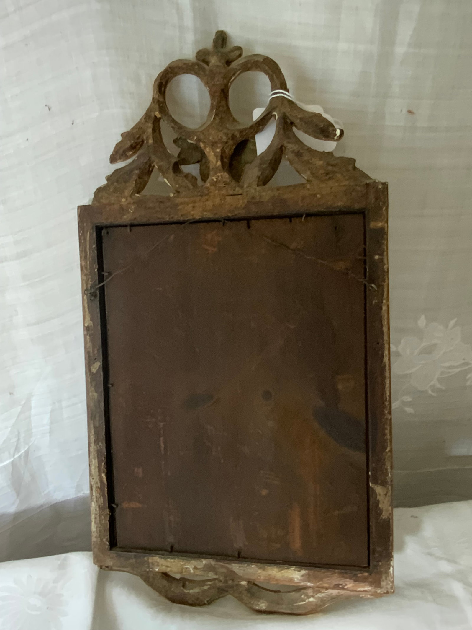 Gold Filigree Mirror: Mirror, gold filigree, 18" tall x 10" wide, has lost most of its reflecting silver. Overall good condition.