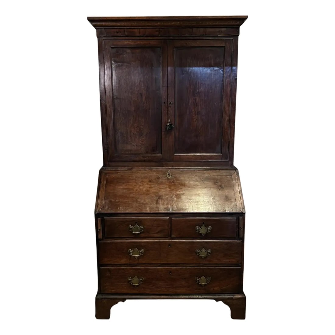 18th-Century Georgian Oak Bureau Bookcase: The moulded cornice above a pair of panelled cupboard doors over a fall front - with elaborated fitted interiors. Has an organic grain on the doors and sides. The interior of the top section is most