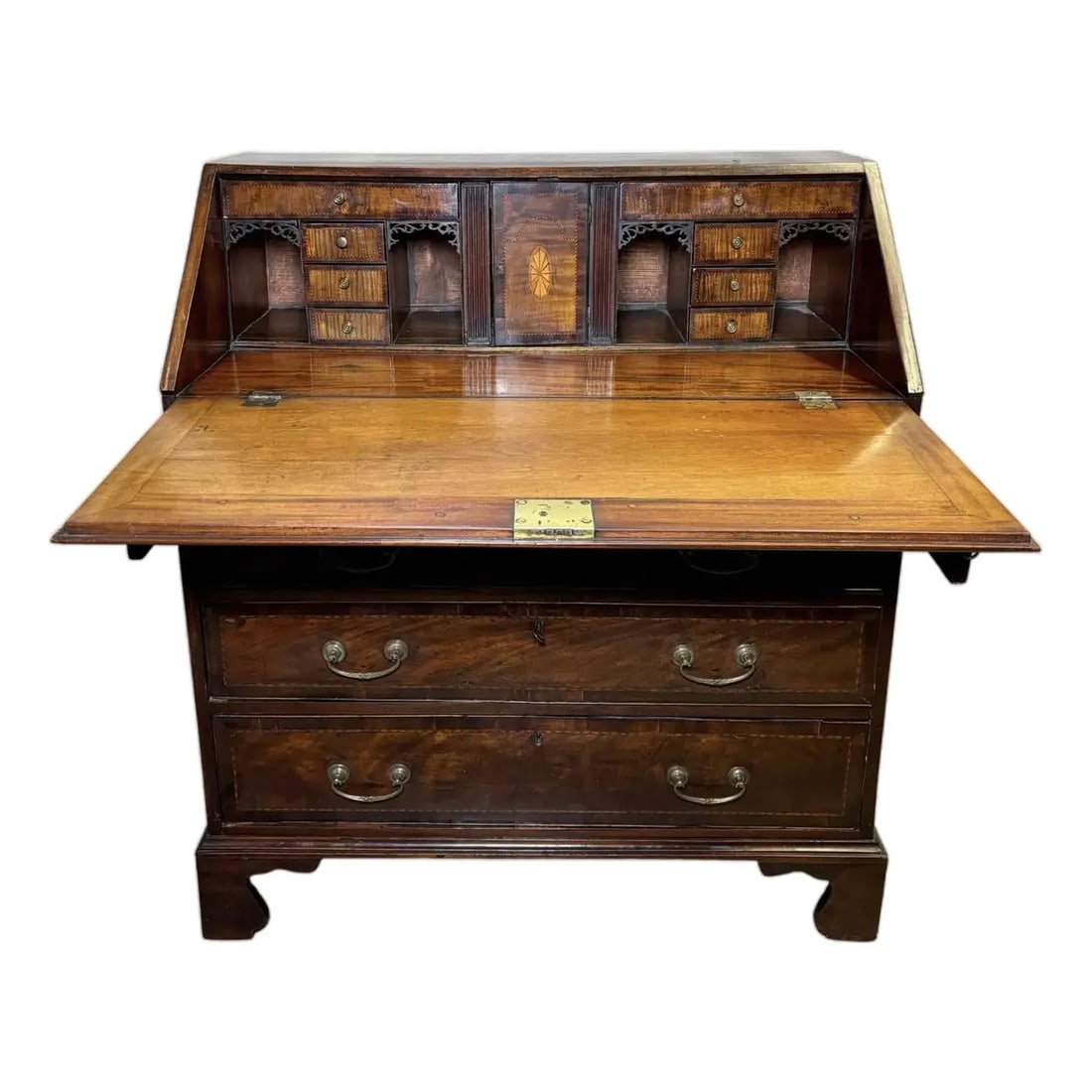 English Mahogany George III Slant Top Desk: This charming late 18th-century George III period Mahogany bureau showcases exquisite craftsmanship and timeless appeal. The fall front opens to reveal a well-organized interior, featuring pigeonholes