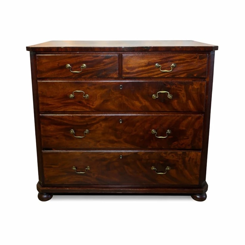 18th Century English Chest of Drawers: Early mahogany crotch mahogany circa 1735. 2 small drawers over 3 larger ones on four bun feet. Inner drawers are made from Quarter Sawn Oak with pin shaped dove-tail joints.Brass hardware is all orig