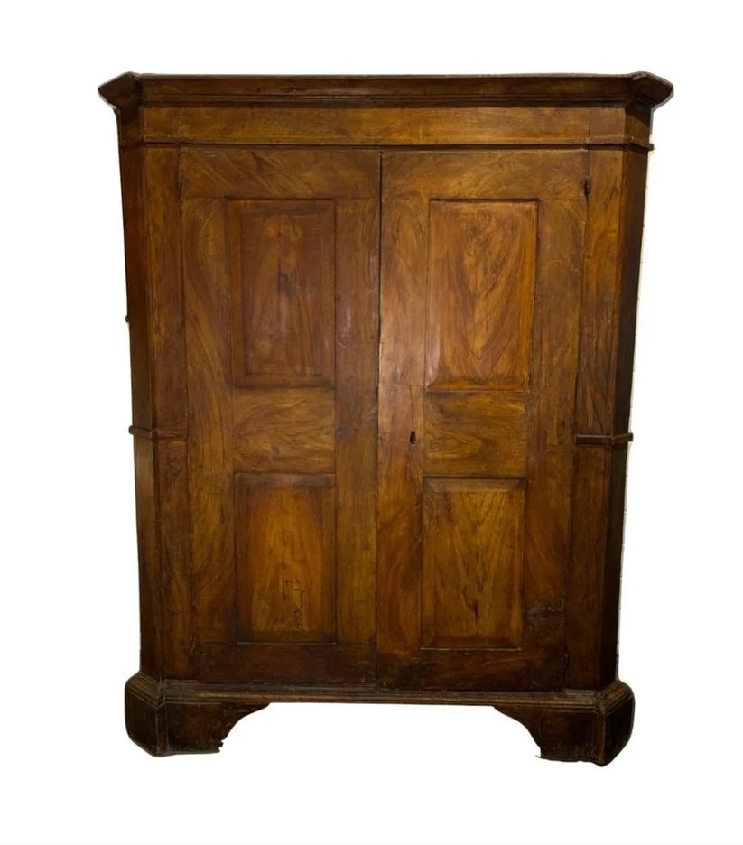 Italian Neo-Classic Armoire: This exquisite 18th-century Italian wood cabinet showcases timeless craftsmanship with its rich patina. Originally crafted from sturdy wood, the cabinet features a stunning hand-painted finish resembl