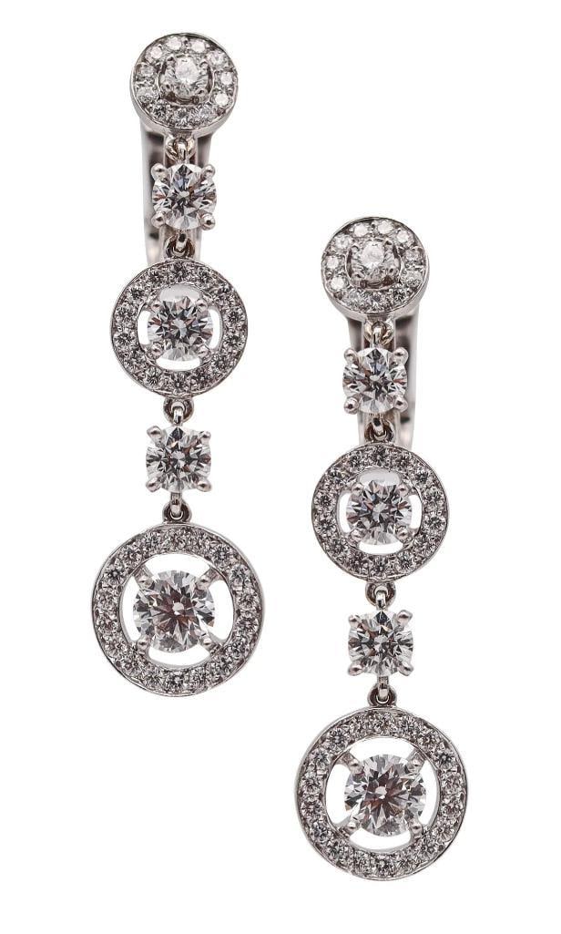 Boucheron “Ava” 18Kt & Diamond Dangle Earrings: Boucheron (French, est. 1858) “Ava” Diamond Dangle Earrings 18K white gold and diamonds Pair of contemporary dangle earrings from Boucheron’s Ava collection, each composed of three g