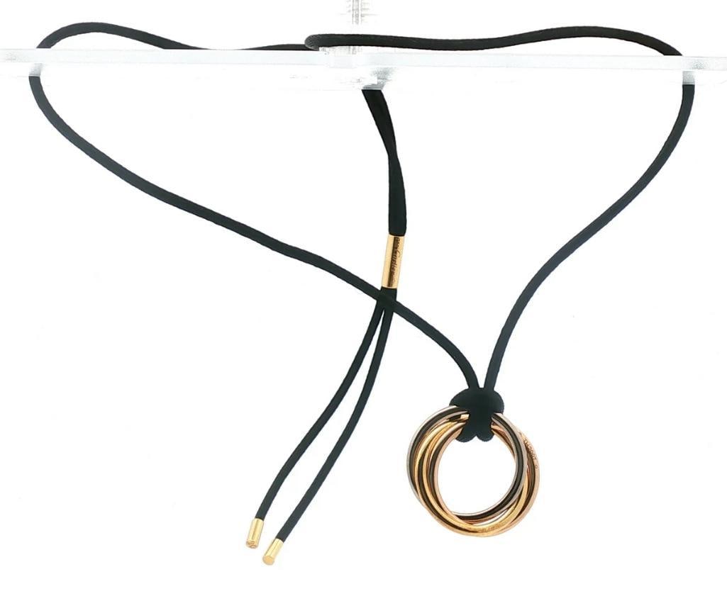 Cartier “Trinity” 18K Tri-Color Gold Adjustable Cord Necklace: Cartier (French, est. 1847) “Trinity” 18K Tri-Color Gold Adjustable Cord Necklace Cartier “Trinity” necklace featuring three independently rotating bands in 18K white, yellow a