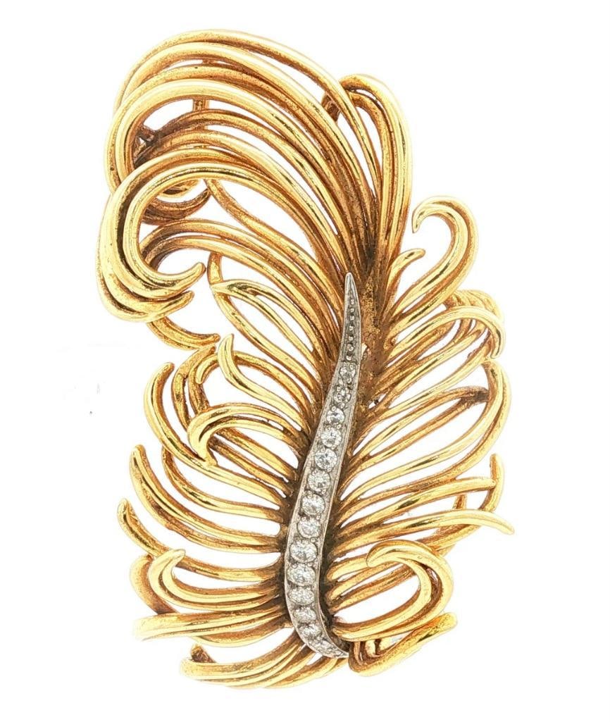 Tiffany & Co. 18Kt & Diamond Feather Brooch: Tiffany & Co. (American, est. 1837) 18K Yellow Gold & Diamond Feather Brooch Tiffany & Co. 18K yellow gold feather brooch featuring an open-wire naturalistic design with individual strands