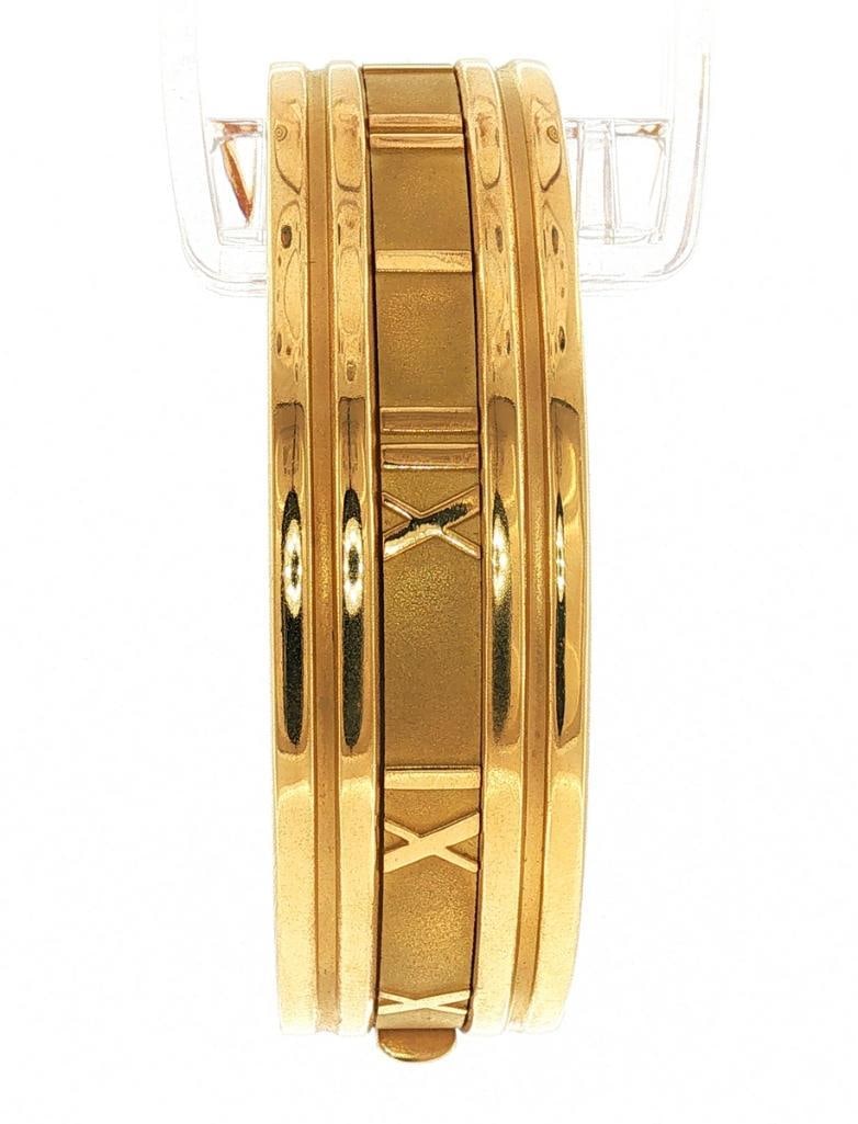 Tiffany & Co. “Atlas” 18Kt Bangle Bracelet: Tiffany & Co. (American, est. 1837) “Atlas” 18K Yellow Gold Bangle Bracelet Tiffany & Co. “Atlas” 18K yellow gold bangle bracelet featuring the house’s signature 