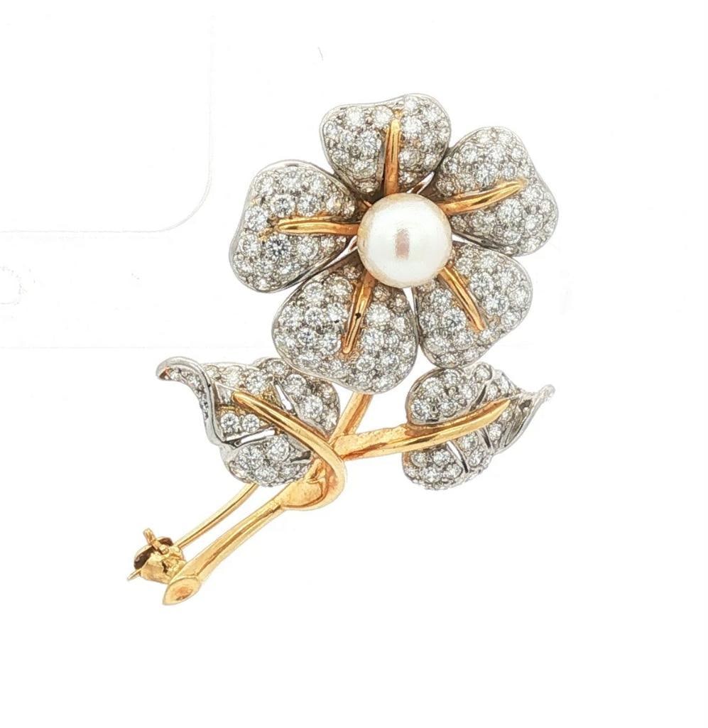 Tiffany & Co. 18Kt Two-Tone Diamond & Pearl Flower Brooch: Tiffany & Co. (American, est. 1837) 18K Yellow & White Gold, Diamond & Pearl Flower Brooch Tiffany & Co. 18K yellow and white gold flower brooch designed as a five-petal blossom on a l