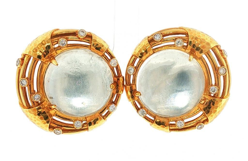 Andrew Clunn 18Kt Quartz & Diamond Ladies Earrings: Andrew Clunn (American) 18K Yellow Gold, Quartz & Diamond Ladies Earrings Andrew Clunn 18K yellow gold button earrings, each centered by a 22 mm domed quartz cabochon set within an openwork gold g