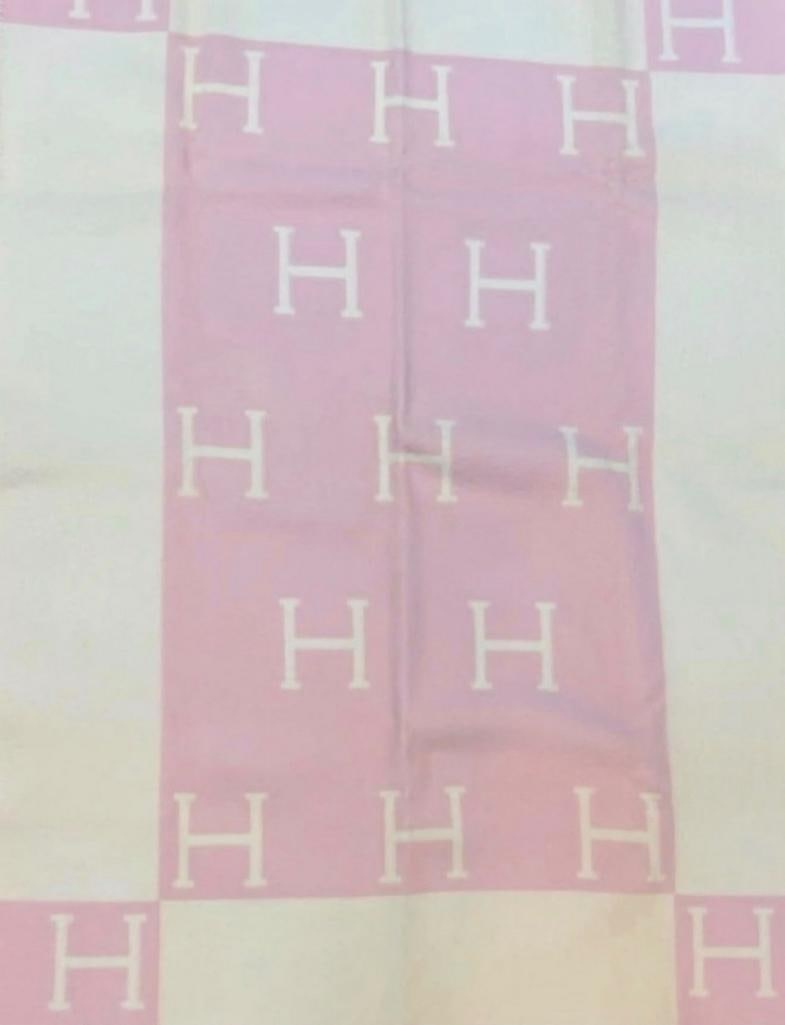 Hermès Rose Airelles and Blanc Wool & Cashmere Baby Blanket: Hermès (French, est. 1837) Rose Airelles and Blanc Baby Blanket Merino wool and cashmere Hermès baby blanket in Rose Airelles and Blanc, featuring the signature “H” motif and col