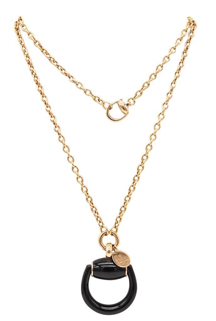 Gucci "Horsebit" 18Kt & Black Enamel Pendant Necklace: Gucci (Italian, est. 1921) Horsebit Pendant Necklace 18K yellow gold and black enamel Circa 1990s Vintage necklace featuring a polished 18K yellow gold chain suspending a sculptural horsebit-form pend