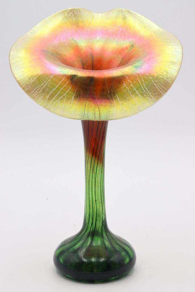 Lundberg Studios Iridescent Art Glass Tulip Vase: Lundberg Studios (American, est. 1970) Iridescent Art Glass Tulip Vase Circa 2005 Art glass vase with a tall green stem rising to a broad, undulating tulip-form rim, displaying a vibrant iridescent su