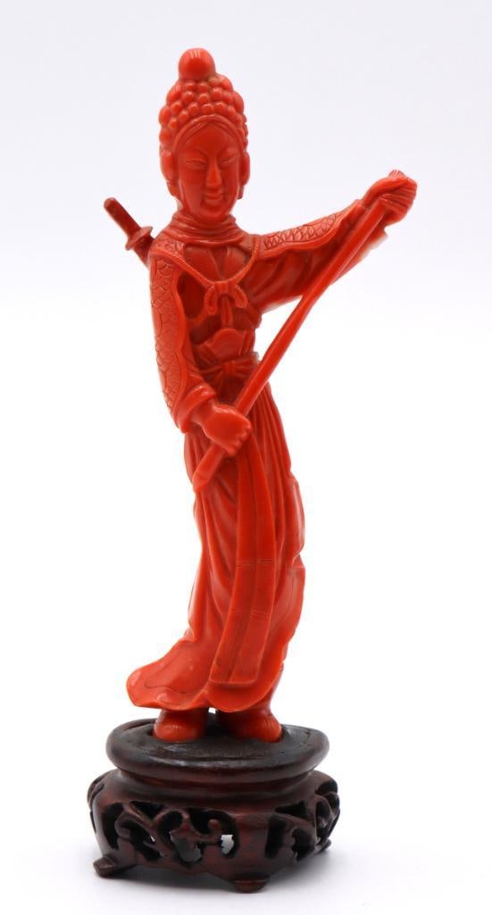 Chinese Woman Warrior Carved Coral Sculpture: Chinese Woman Warrior Carved coral sculpture on wooden stand Carved coral figure depicting a female warrior in traditional attire, modeled standing and holding a long staff, with a sword at her back. 