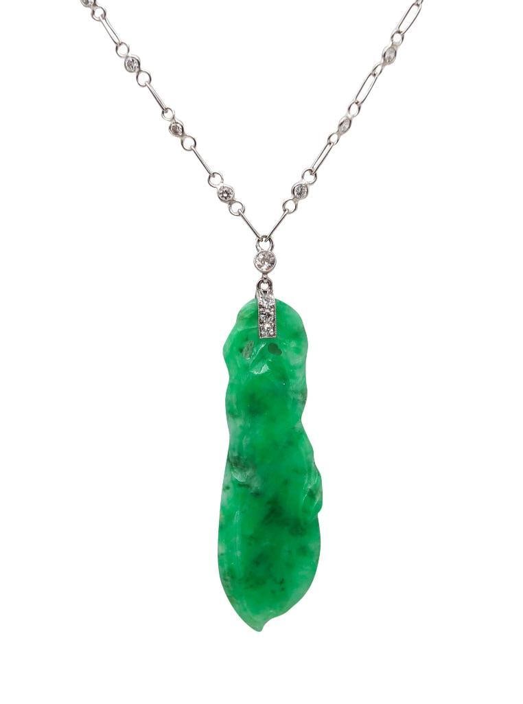 European Art Deco Platinum Jadeite & Diamond Pendant Necklace: European, Art Deco Period Jadeite and Diamond Pendant Necklace Platinum Circa 1920 Art Deco pendant necklace featuring a natural translucent green jadeite carving in the form of a leaf, suspended from