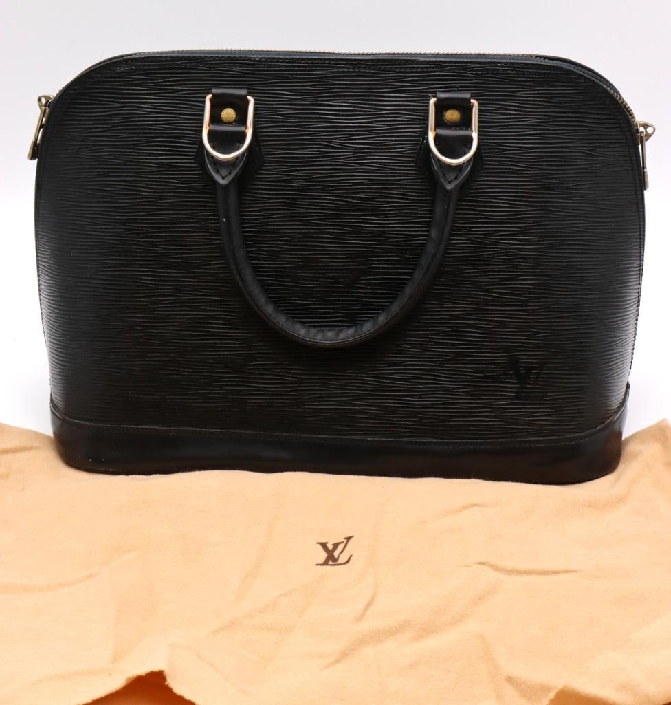 Louis Vuitton Black Epi Leather Alma Bag: Louis Vuitton (French, est. 1854) Vintage Alma Bag Black Epi leather Vintage Louis Vuitton Alma handbag crafted in black Epi leather with signature textured finish and smooth leather trim. Designed wi