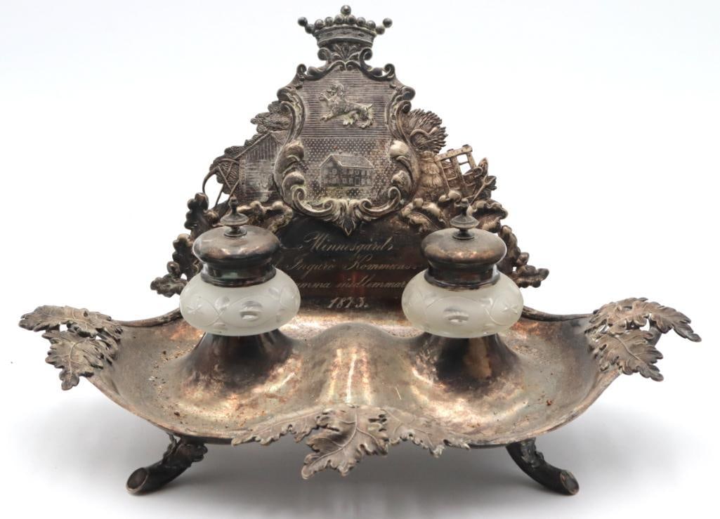 Late 19th C. English Silver-Plated Footed Inkwell: English, Late 19th Century Silver-Plated Footed Inkwell 1879 Elaborate silver-plated inkwell featuring two frosted glass ink reservoirs with hinged covers, set within a shaped footed tray embellished 