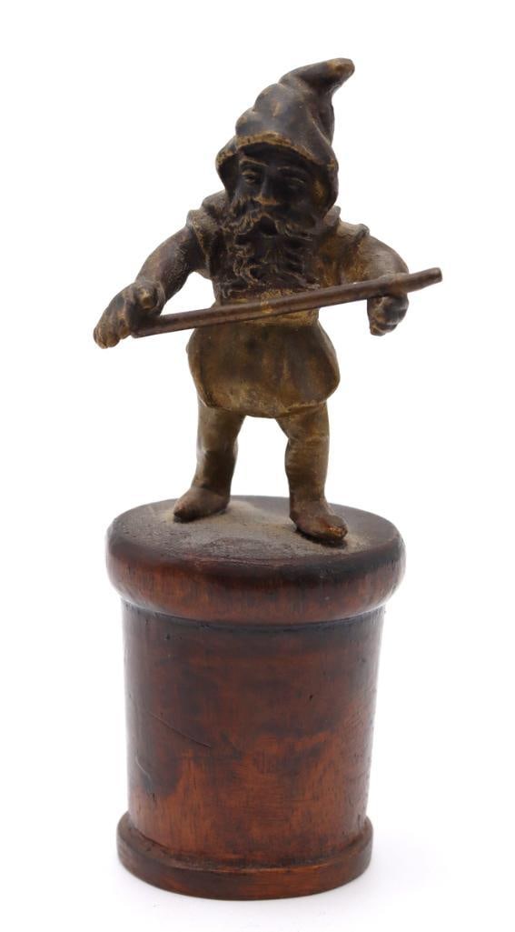 French School (Early 20th C.) "Gnome" Bronze Sculpture: French School (Early 20th Century) Gnome Figure Patinated bronze on wooden base Miniature bronze sculpture depicting a bearded gnome wearing a pointed cap and holding a staff, mounted on a turned wood
