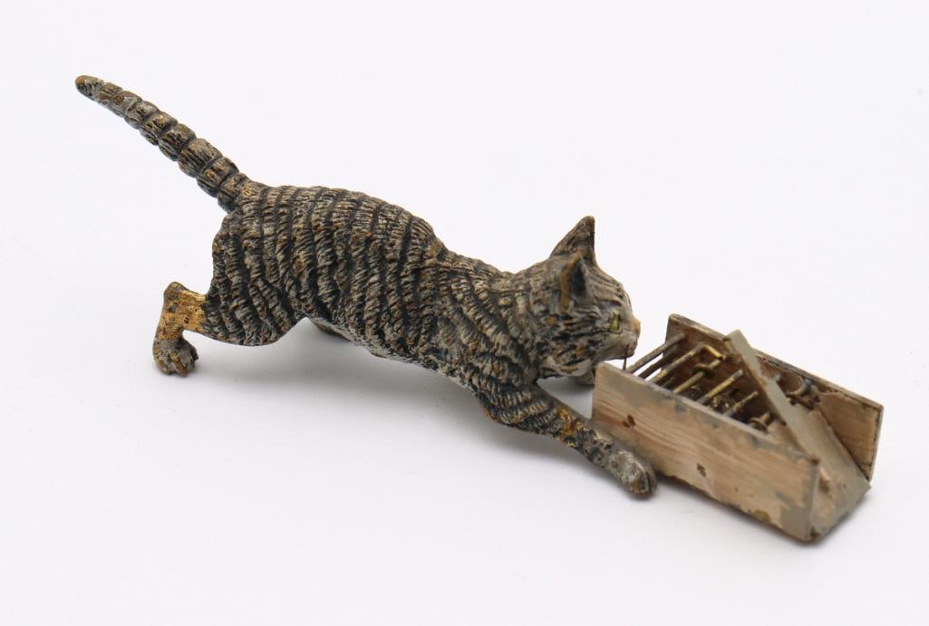 Vienna Cold-Painted Bronze Cat and Mousetrap Sculpture: Vienna Cold-Painted Bronze Cat and Mousetrap Sculpture Vienna cold-painted bronze figural sculpture depicting a cat investigating a mouse caught in a mousetrap. Measurements approx. - 3 3/4 in. long. 