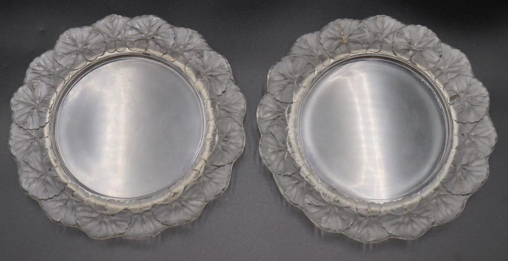 Pair of Lalique “Honfleur” Crystal Plates: Pair of Lalique (French, est. 1888) “Honfleur” Plates Clear and frosted crystal Pair of circular crystal plates featuring a clear central well surrounded by a sculptural border of overlapp