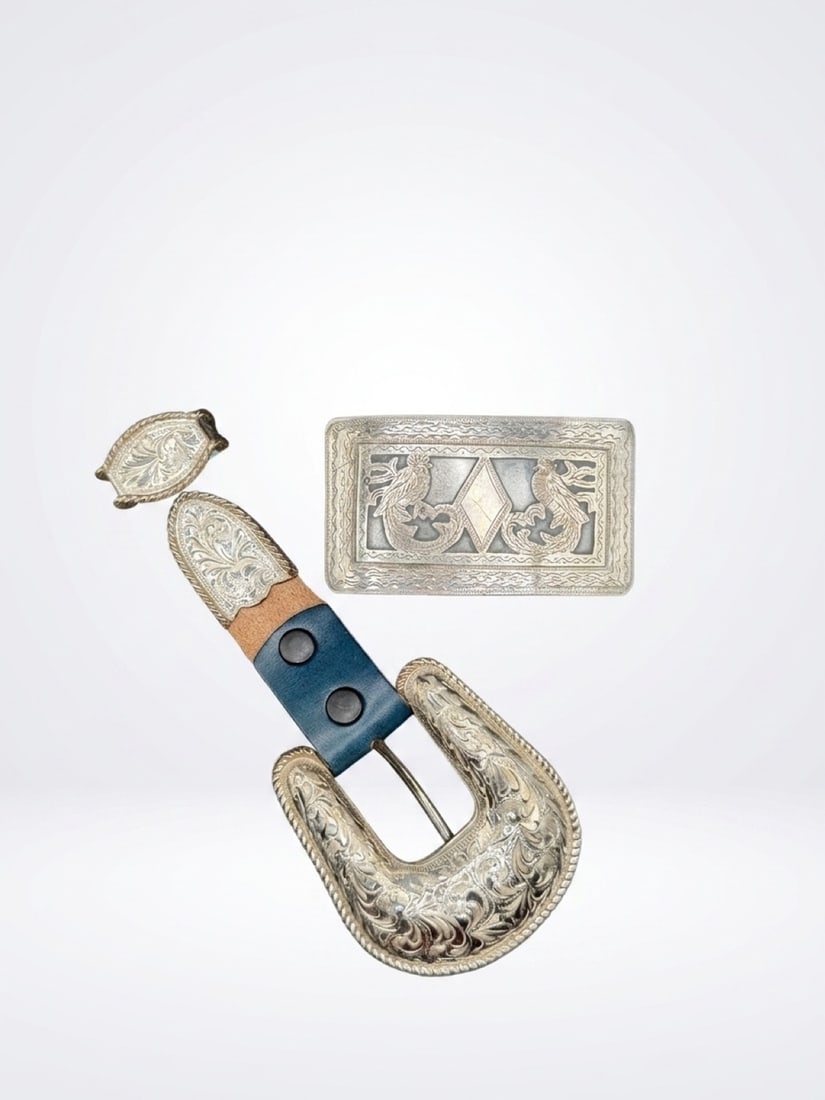 A pair of sterling silver belt buckles: One Montana silver smith with engraving marked sterling and one engraved with twin birds engraving marked 925