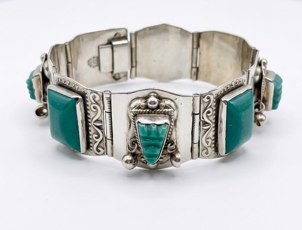 Taxco vintage mask bracelet: Vintage Taxco green onyx mask bracelet featuring panels with scrollwork and greeen onyx masks and stones marked Mexico 925 Taxco