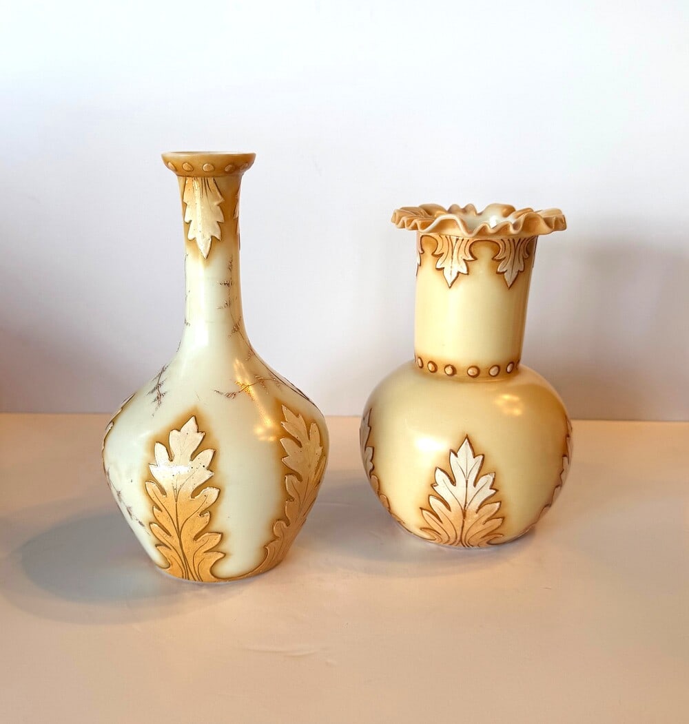 A fine pair of staggered Victorian "ivory" cameo vases circa 1890 England: A pair of cameo vases "ivory glass" English circa 1890 made to emulate whale ivory carving one is 8" inch and the other is 6"inch decorated with oak leaves and trailing vine