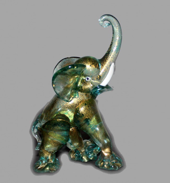 Bullicante BLown Glass Elephant By Barovier: This is a Murano blown glass bullicante gold dusted Green colored glass elephant made by Master Glass Blower Barovier. It has applied white tusks. DIMENSIONS: Length: 4.25 inches Width: 2.5 inches Hei