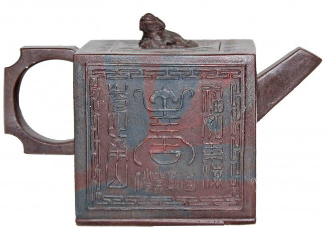 Chinese Yixing Teapot: This is a brown and black fired clay Chinese Yixing teapot Chinese characters and chop marks underneath. DIMENSIONS: Length: 5.5 inches Width: 2.5 inches Height: 3.75 inches