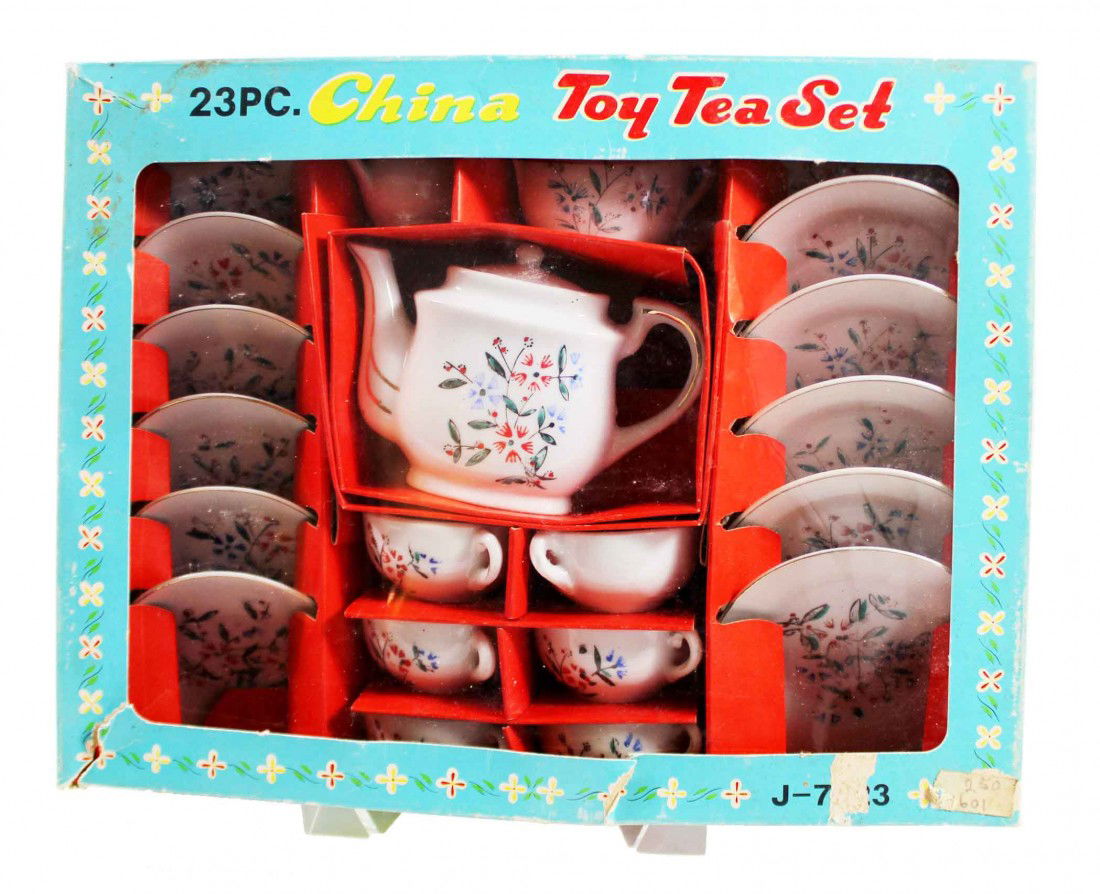 Toy Tea set in original box: 23 piece china toy tea set in original box. 6 plates, 6 saucers, 6 cups, sugar, creamer and pitcher with lid. Has a blue & orange flower design with gold rims. Made in Japan.