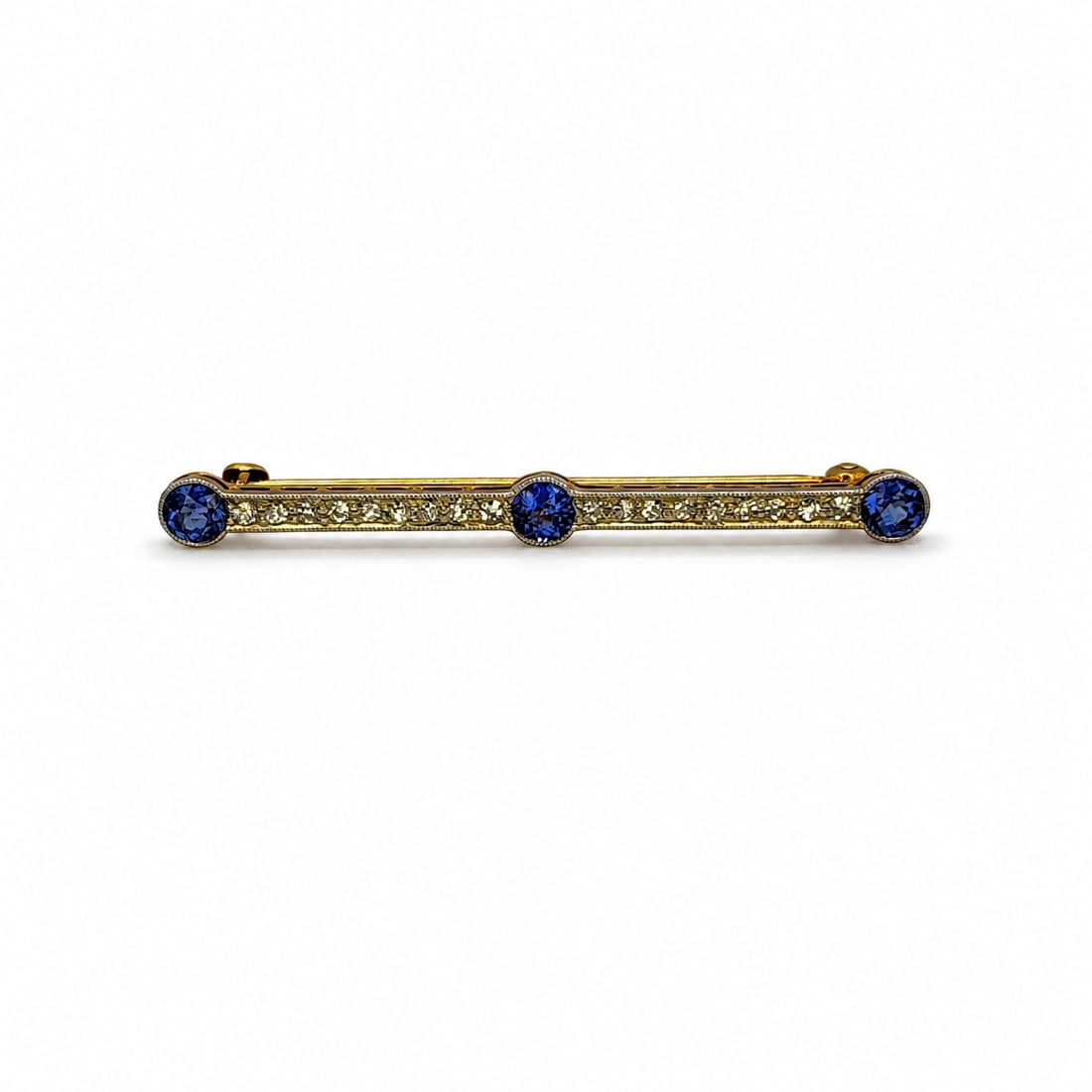 Yellow gold sapphire & diamond pin: A 14kt yellow gold pin. Sapphire .60cts. Diamonds .15cts. 1.75x.15 inches. 2.35 grams. Topped with white gold.