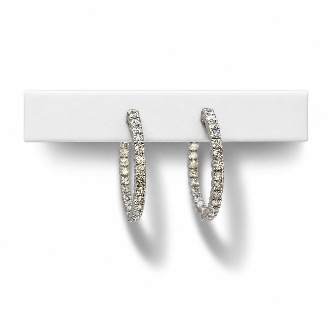 White gold diamond hoop earrings: A 14kt white gold earrings. Diamonds 2 ct tw G-H color VS-SI clarity. 1.00x1.00 inch. 6.25 grams