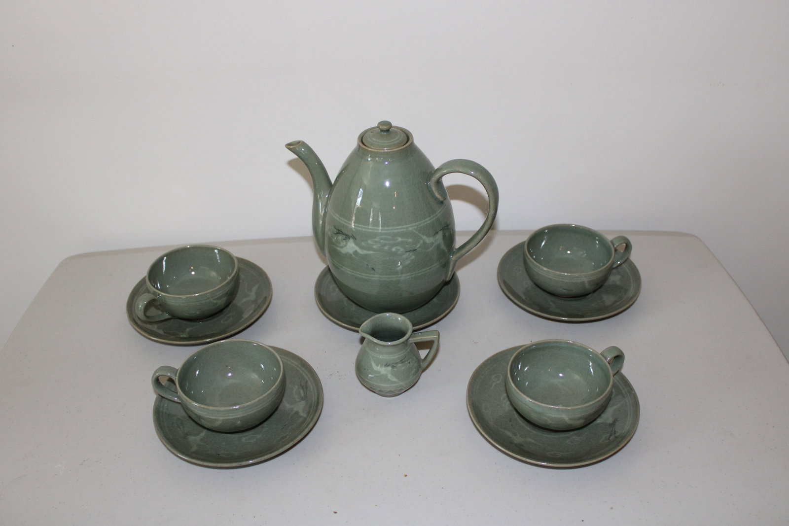 Traditional Korean Celadon Ceramic tea set soft green glaze: Traditional Korean Celadon Ceramic tea set soft green glaze with delicate crane and cloud motifs. Teapot with lid, 5 saucers, 4 teacups, 1 creamer