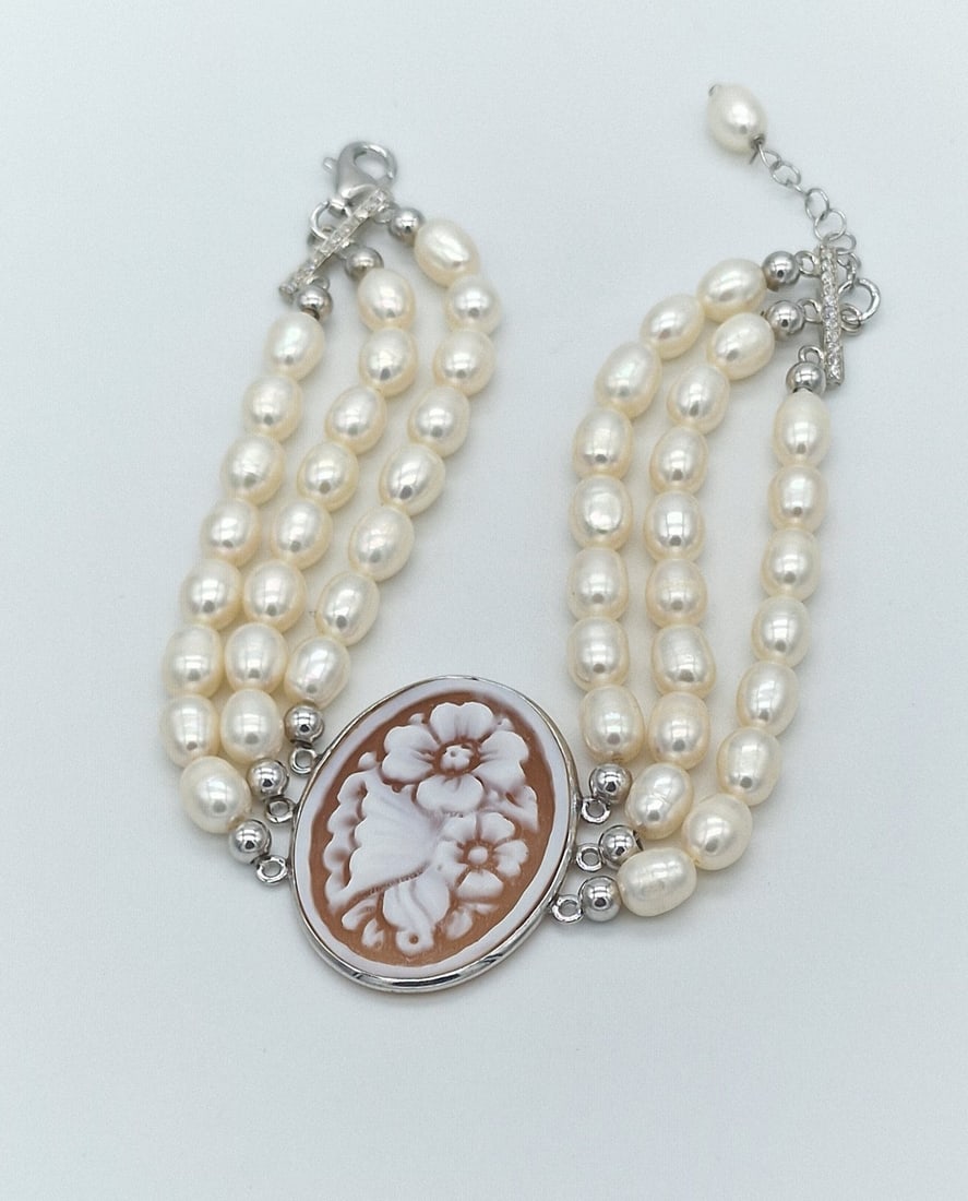 Triple-Strand Pearl Bracelet with Cameo Centerpiece and 925 Silver Clasp: Metal: 925 Sterling Silver Clasp / Total Item Weight: 26.50 Grams / Pearl Type: Freshwater Cultured Pearls / Pearl Size: 6.2 mm / Luster: Excellent / Centerpiece: Hand-carved Cameo made in Torre del G