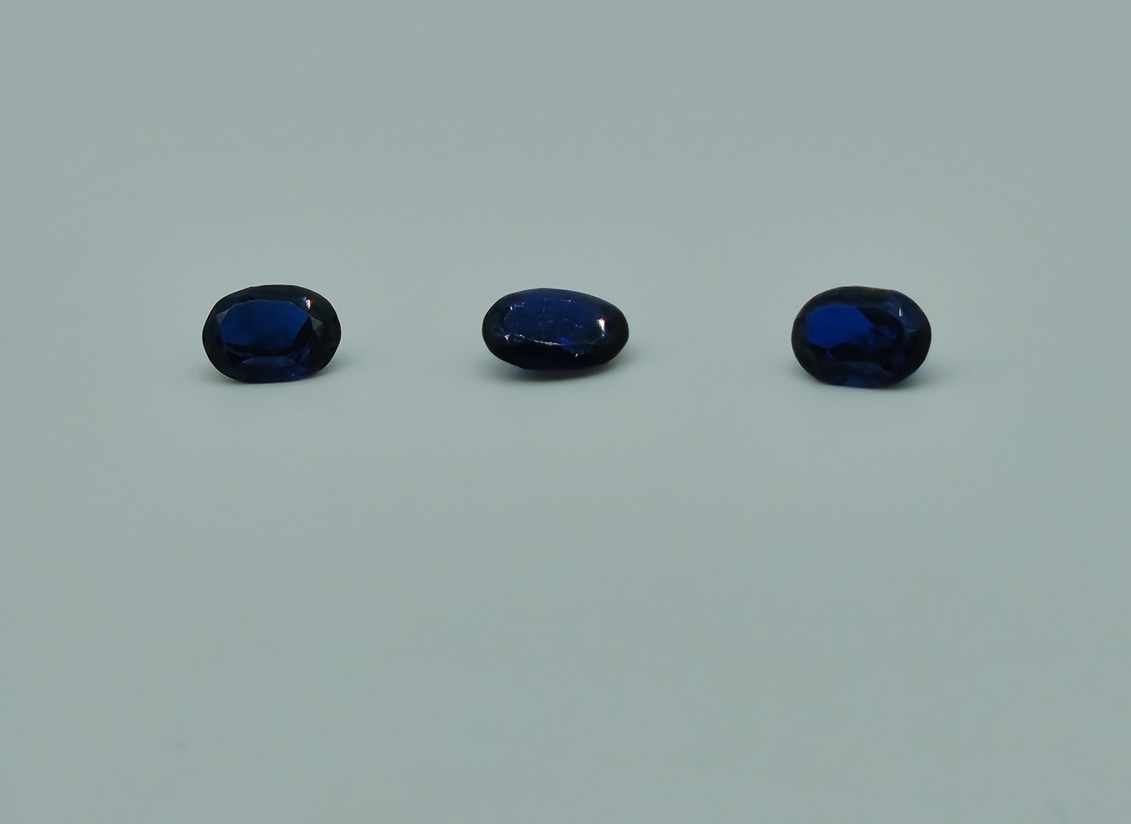 Natural Blue Sapphire Lot - 3 Oval Cut Stones, 1.80 Carats Total: Natural Blue Sapphire Lot / Quantity: 3 Stones / Stone Type: Natural Sapphire / Total Carat Weight: 1.80 ct / Individual Stone Weight: Approx. 0.60 ct each / Stone Shape: Oval / Dimensions: Approx. 7 