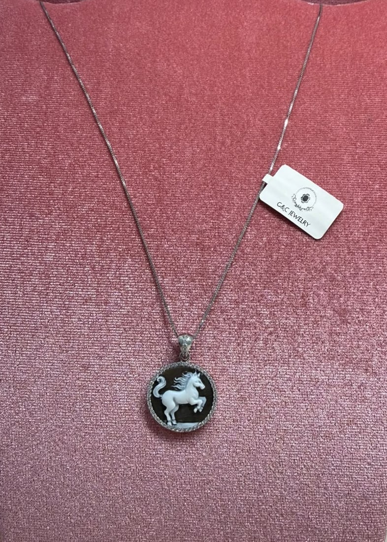 925 Sterling Silver Rhodium-Plated Necklace with Round Rearing Horse Shell Cameo and Zirconia: Metal: 925 Sterling Silver with Rhodium Plating / Chain Length: 45 cm / Gemstone: Cubic Zirconia / Design: Handcrafted round shell cameo meticulously carved in high relief, depicting a magnificent rea