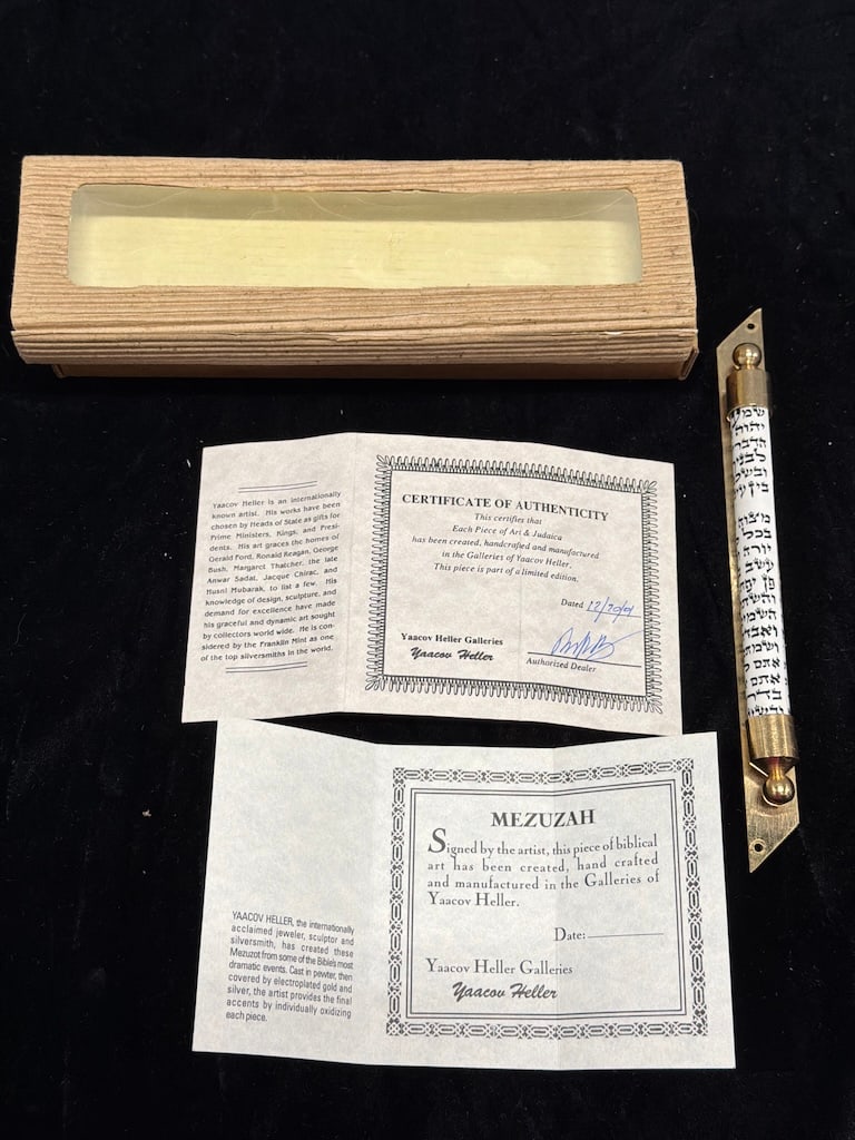 Judaica Silver & Gold-Tone Mezuzah with Yaacov Heller-Related Documentation LF: Decorative Judaica mezuzah featuring a silver-tone body with gold-tone accents and Hebrew lettering along the front. The piece is accompanied by a fitted presentation box and paperwork/documentation a