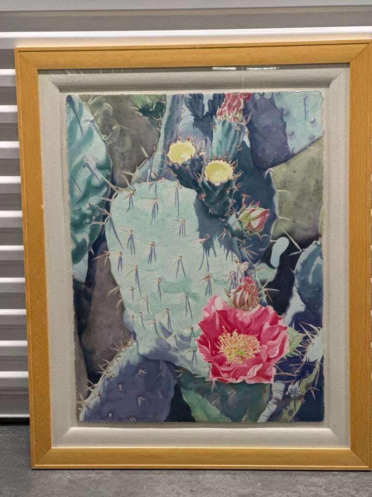 Vintage Southwestern Prickly Pear Cactus Flower Fine Art Watercolor Painting: A beautiful vintage Southwestern regional watercolor illustration showcasing a dense cluster of prickly pear cactus pads. The composition highlights a vibrant, highly detailed pink and magenta cactus 
