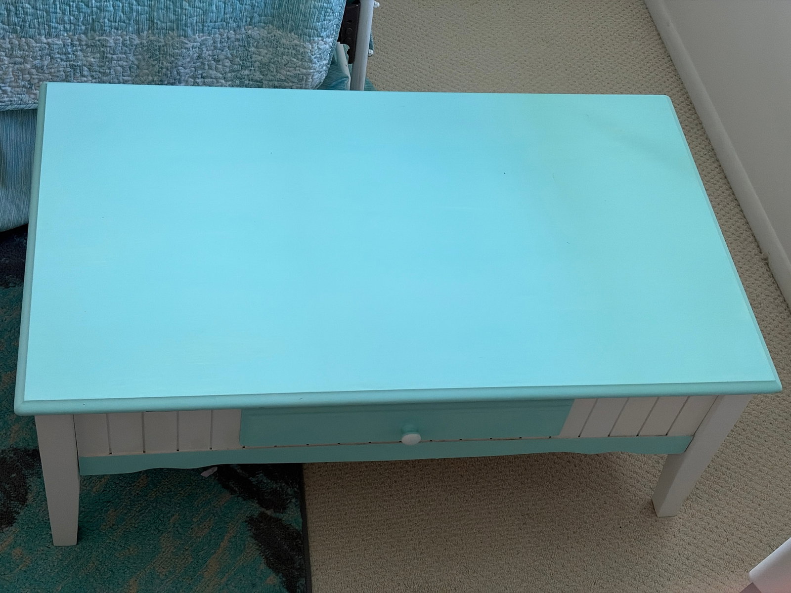 Coastal Cottage Painted Wood Coffee Table with Drawer: Rectangular coffee table in aqua and white painted finishes, featuring a molded-edge top, paneled apron, single drawer with a round knob, and four straight legs. Photographs indicate approximate dimen