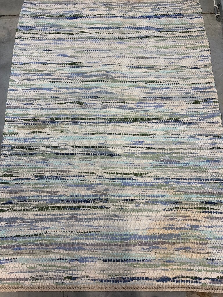 Handwoven Multi-Color Area Rug: "Handwoven Multi-Color Area RugHandwoven area rug featuring a mix of blue, green, and white stripes, crafted from textile materials."