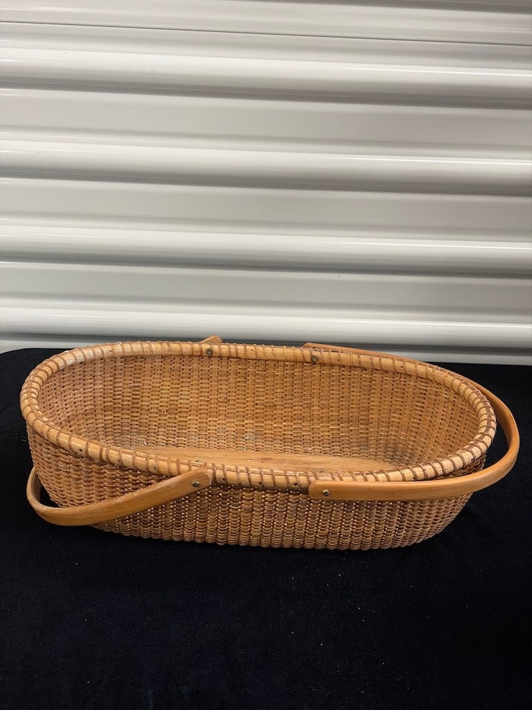Vintage Handwoven Oval Nantucket-Style Basket with Wooden Base: Vintage Nantucket-style oval basket featuring tightly handwoven construction over a solid wooden base with a classic coastal New England form. Nicely crafted decorative basket with warm natural