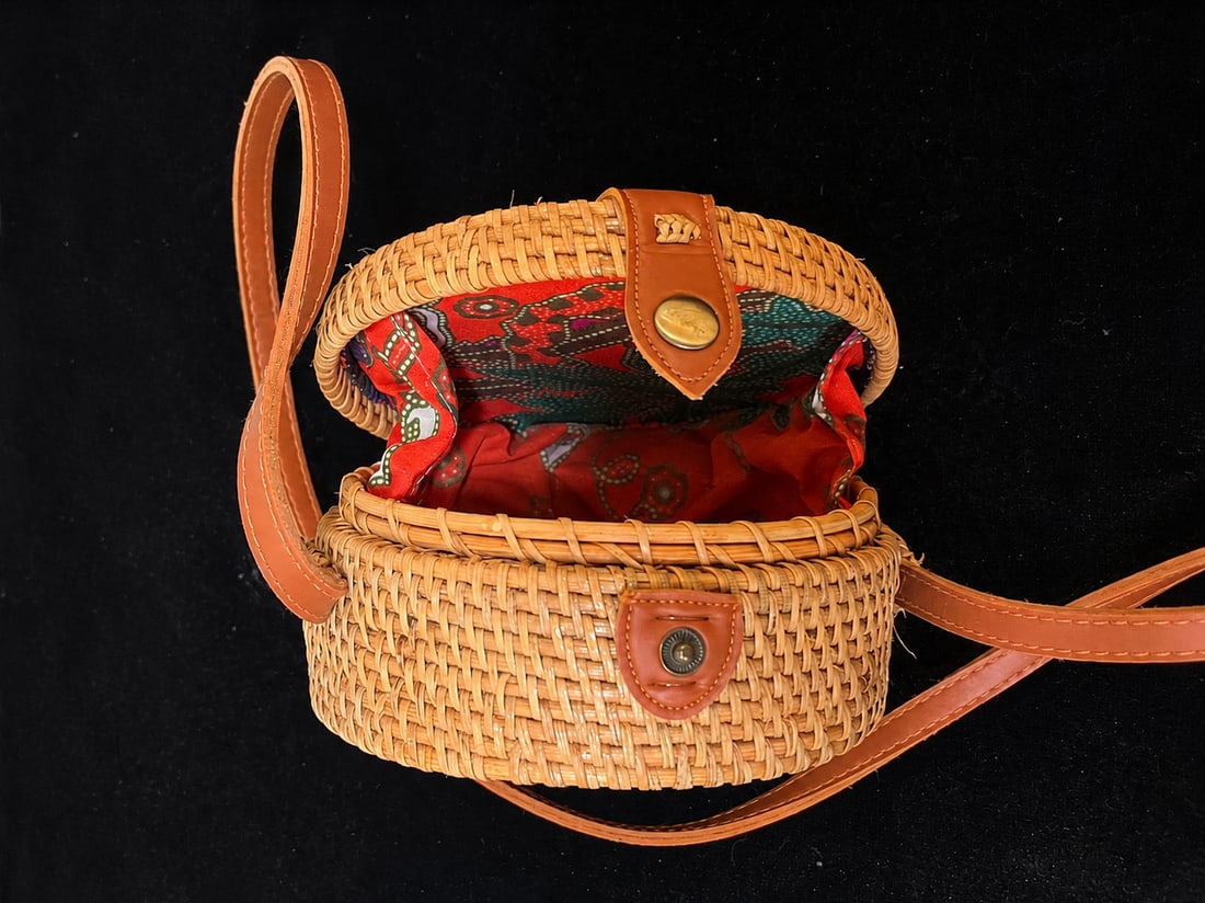 Handcrafted Woven Rattan Crossbody Bag: "Round Woven Rattan Crossbody Purse with Leather StrapCharming round woven rattan handbag featuring a natural basket-weave construction, long brown leather shoulder/crossbody strap, snap closure, and 