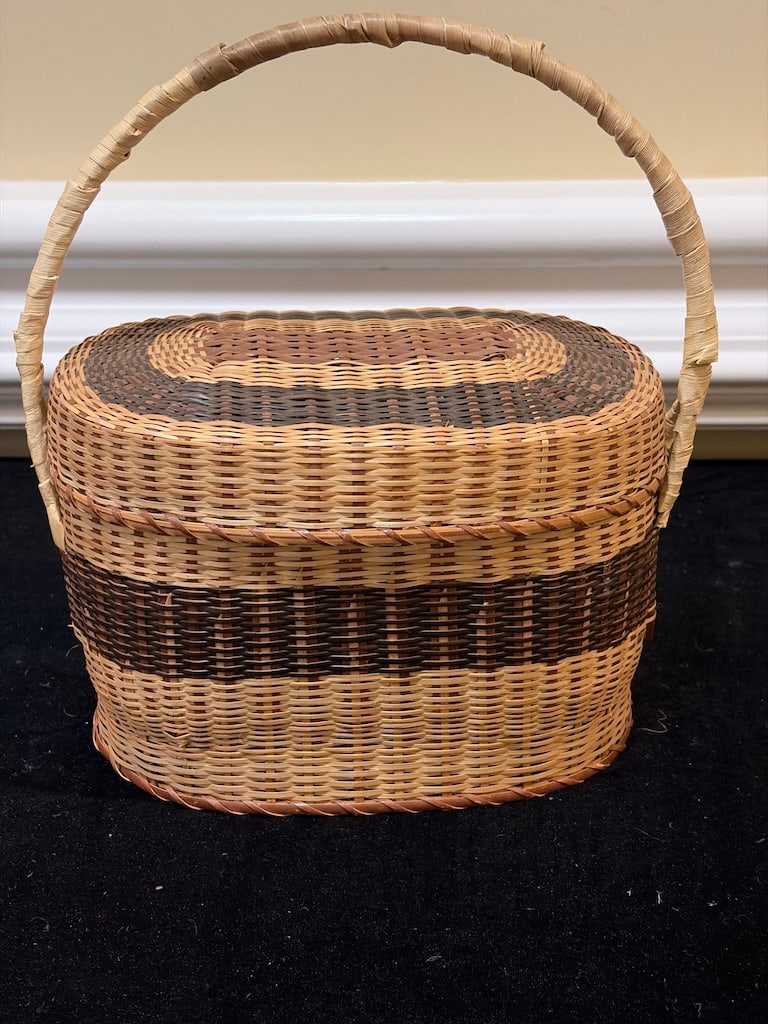 Vintage Handwoven Decorative Basket with Handle: "Handwoven Decorative Basket with HandleThis is a handwoven basket in natural and dark brown tones, featuring a sturdy handle and intricate striped patterns. Approximately 11"" tall including handle."