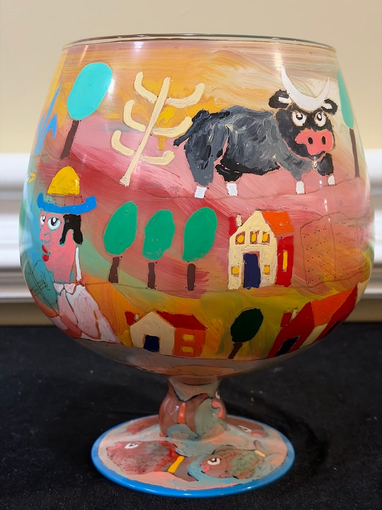 Large Signed & Dated Folk Art Hand-Painted Glass Goblet, 2015: "Large Signed & Dated Folk Art Hand-Painted Glass Goblet, 2015Large one-of-a-kind hand-painted glass goblet featuring a colorful naïve folk-art scene with a figure, sheep, bird, houses and landscape 