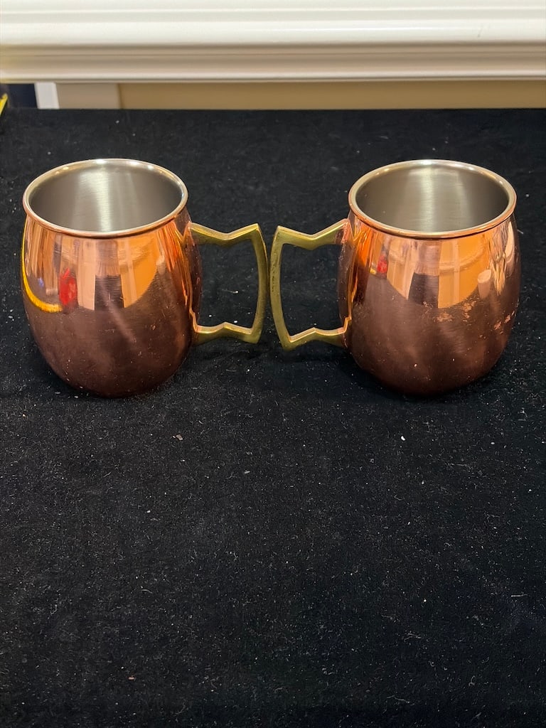 Pair of Jodhpuri Copper-Finish Stainless Steel Moscow Mule Mugs: "Pair of Jodhpuri Copper-Finish Stainless Steel Moscow Mule MugsPair of Jodhpuri, Inc. Moscow Mule mugs featuring stainless steel construction with a polished copper finish and angular brass-tone