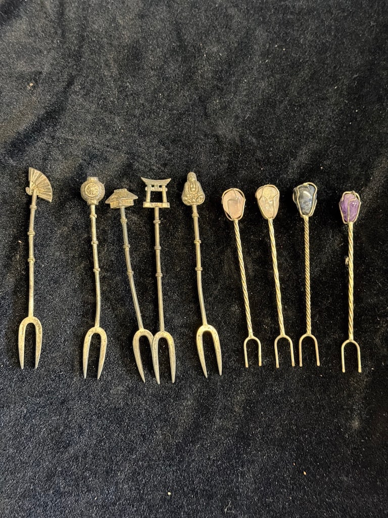 Vintage Japanese Sterling Silver Figural Cocktail Forks & Stone-Set Picks – 9 Pieces: Collection of nine vintage Japanese-style cocktail/hors d’oeuvre forks, including five marked “Japan Sterling” with detailed figural finials depicting a fan, Buddha, traditional