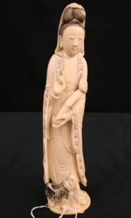 Late 19th Century Japanese Carved Ivory Figure of: Late 19th Century Japanese Carved Ivory Figure of Maitreya Holding Scepter with Foo Dog at Feet. 9.75" Height. Auction Estimate:$400-600.