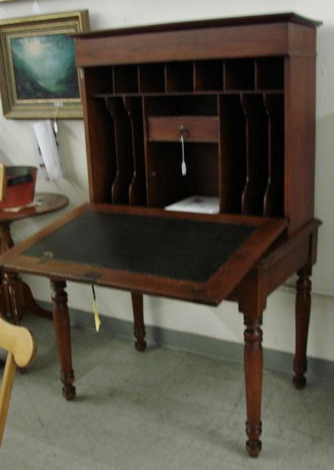 Mid 19th Century American Walnut Plantation Desk, : Mid 19th Century American Walnut Plantation Desk, Pigeon Hole Interior with File Slots, Lift Top Cornice, Single Lower Drawer, Pine Interior ending on Turned Legs. Circa 1850-1870. Auction Estimate $4