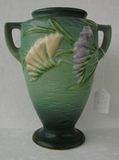 Roseville Art Pottery Green Freesia 2-Handled Vase: Roseville Art Pottery Freesia 2-Handled Vase. Green.. #121/8". Auction Estimate $100-200.
